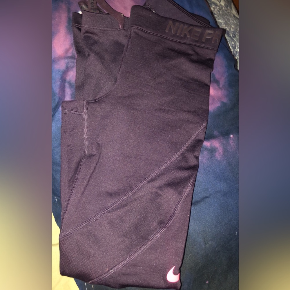Maroon with hot pink Nike logo Nike Pro leggings.